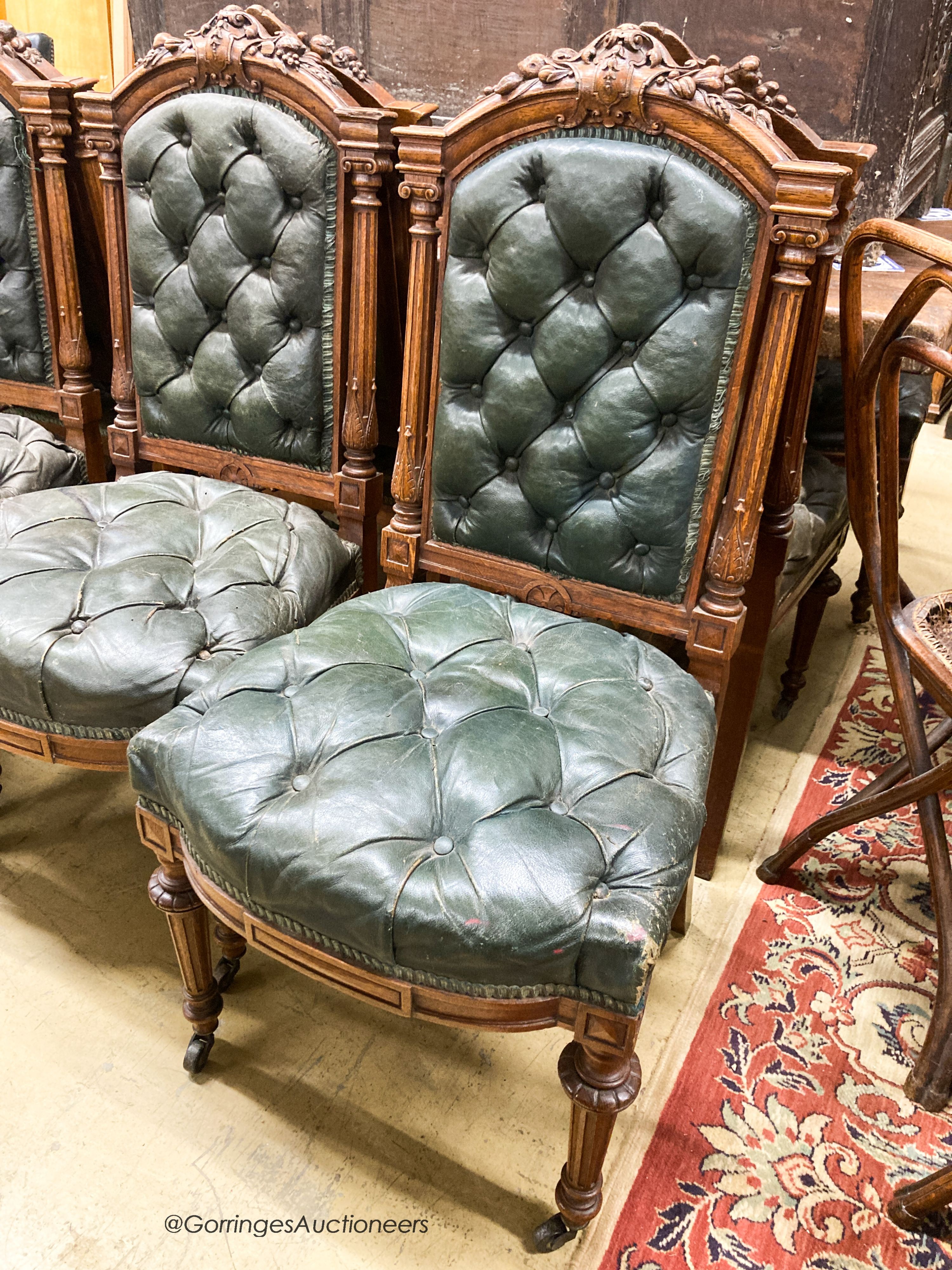 A set of twelve Victorian carved oak buttoned back and seat dining chairs, width 52cm, depth 50cm, height 106cm